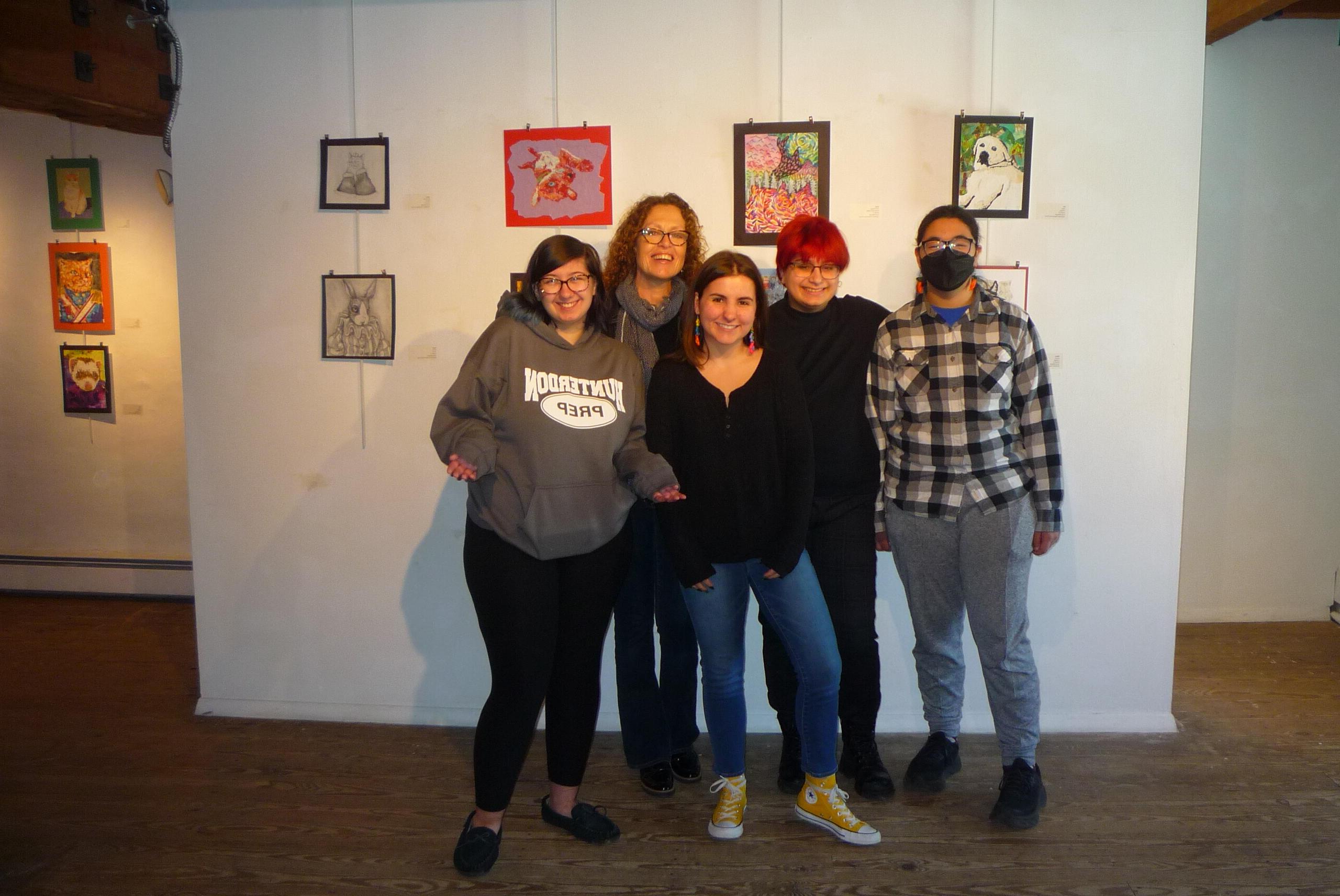 students standing in front of artwork